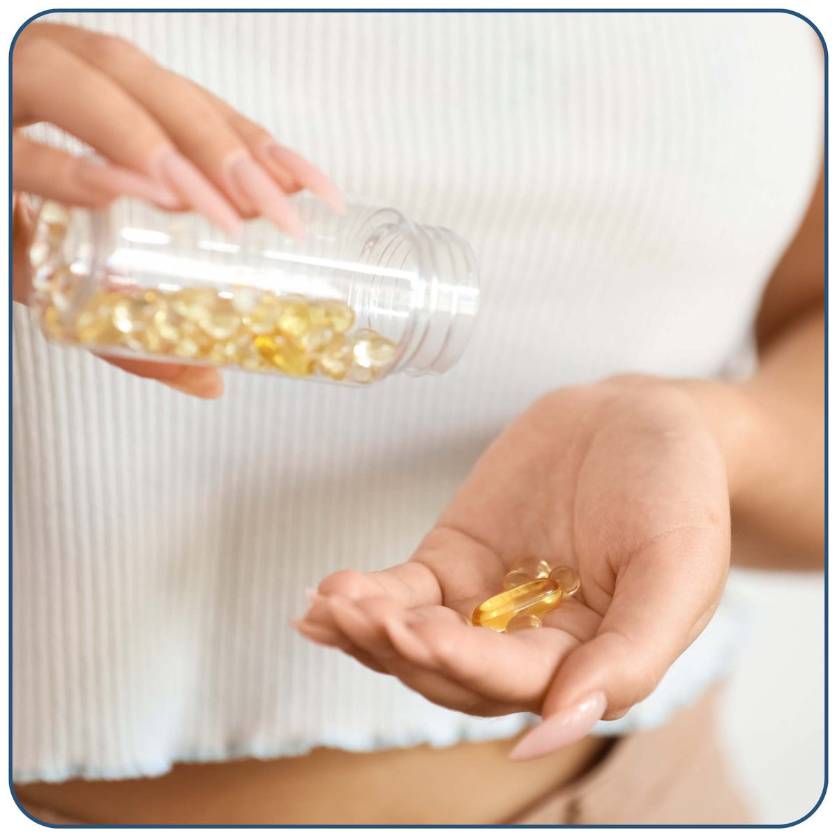 A close-up of a person holding a clear plastic bottle of golden-yellow softgel capsules and pouring a few into their open palm.